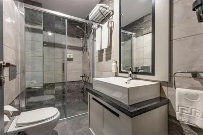 a bathroom with a sink and a toilet and a shower at Garner Hotel Istanbul - Airport Arnavutkoy by IHG in Istanbul