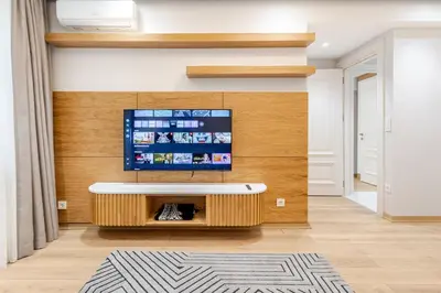 a living room with a tv on a wall at Chido Residence in Istanbul
