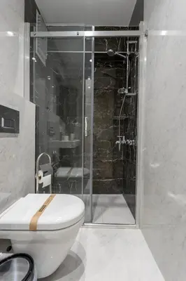 a bathroom with a toilet and a glass shower at Chido Residence in Istanbul