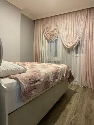 a bedroom with a bed and a window with curtains at TAKSİM CMLM Suit in Istanbul
