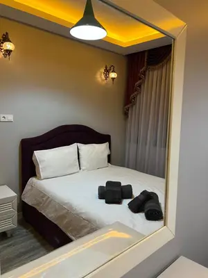 a bedroom with a bed with a mirror on it at TAKSİM CMLM Suit in Istanbul