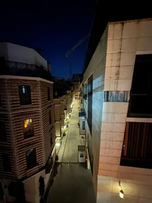 a view of an alley between two buildings at night at TAKSİM CMLM Suit in Istanbul