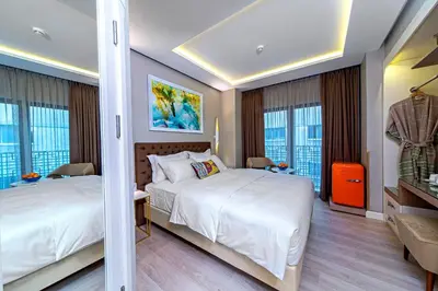 a hotel room with two beds and windows at Barbera Hotel in Istanbul