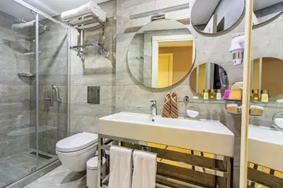 a bathroom with a sink and a toilet and a mirror at Barbera Hotel in Istanbul