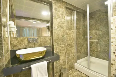 a bathroom with a sink and a shower at Perada Suite & Room in Istanbul