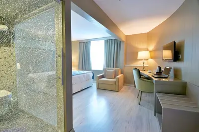 a hotel room with a shower and a desk at Perada Suite & Room in Istanbul