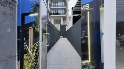 a walkway between two buildings in a city at farazarooms in Serdivan