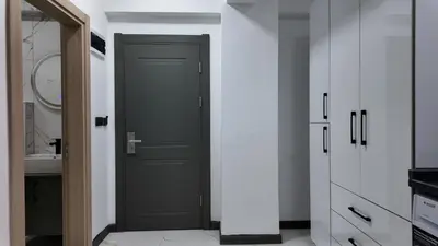 a black door in a kitchen with white cabinets at farazarooms in Serdivan