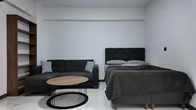 a bedroom with a bed and a couch at farazarooms in Serdivan