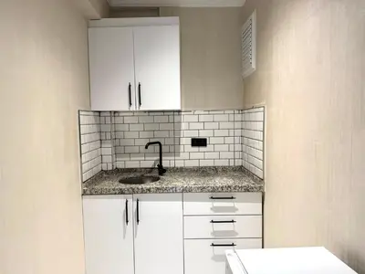 a kitchen with white cabinets and a sink at Serene in Istanbul