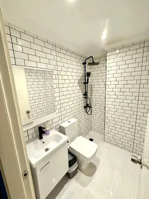 a white bathroom with a toilet and a sink at Serene in Istanbul