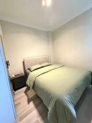 a bedroom with a bed and a night stand at Serene in Istanbul