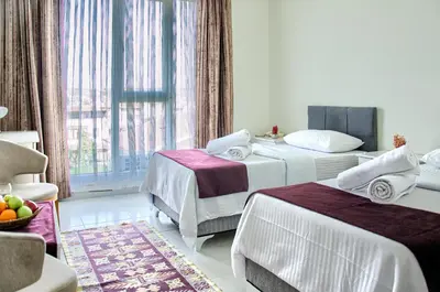 a hotel room with two beds and a window at Hotel yeniçiftlik in Yeniçiftlik
