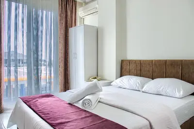 a bedroom with a bed with a large window at Hotel yeniçiftlik in Yeniçiftlik