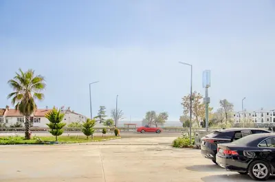 two cars are parked in a parking lot at Hotel yeniçiftlik in Yeniçiftlik