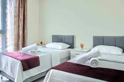 a bedroom with two beds and a window at Hotel yeniçiftlik in Yeniçiftlik