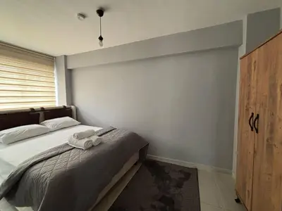 a bedroom with a bed with two towels on it at Zeus Suit Görükle in Nilüfer