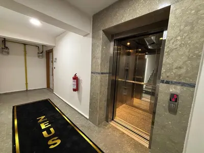 a hallway with a exit sign on the side of a building at Zeus Suit Görükle in Nilüfer