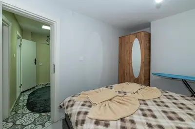 a bedroom with a bed and a table in it at rest at home in Istanbul
