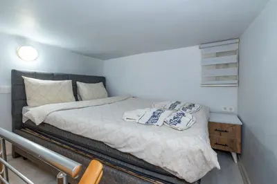a bedroom with a bed with two pillows on it at rest at home in Istanbul