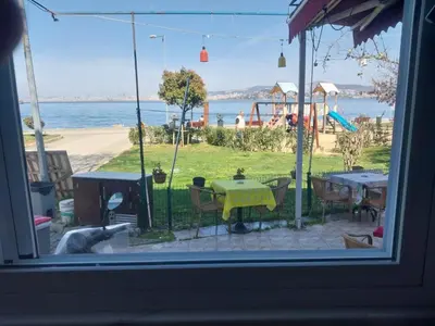 a view from a window of a patio with a table and chairs at Palmiye Pansiyon in Adalar