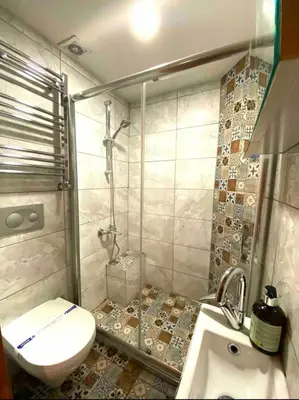 a small bathroom with a toilet and a sink at Authentic Turkish Home Standard Room in Istanbul