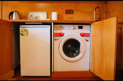 a washer and dryer in a small kitchen at Authentic Turkish Home Standard Room in Istanbul