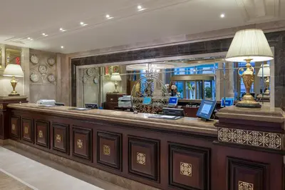 a bar in a hotel lobby with a mirror at Elite World Istanbul Taksim in Istanbul
