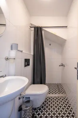 a bathroom with a white toilet and a sink at Raya Cihangir Suites in Istanbul