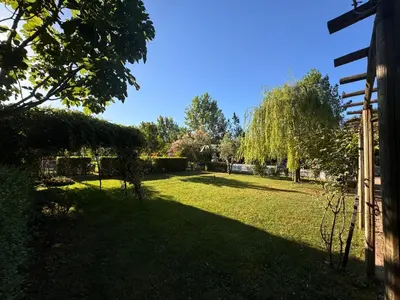 a yard with green grass and trees and a fence at Keyfe Kadir Garden Butik Otel in Orhangazi