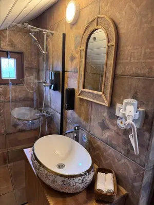 a bathroom with a sink and a mirror at Keyfe Kadir Garden Butik Otel in Orhangazi