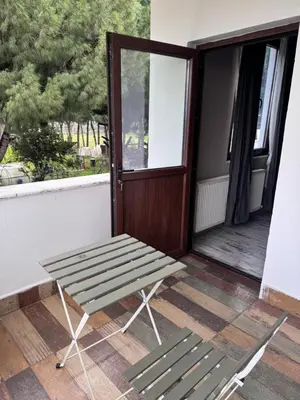 a bench sitting on the porch of a house at Keyfe Kadir Garden Butik Otel in Orhangazi