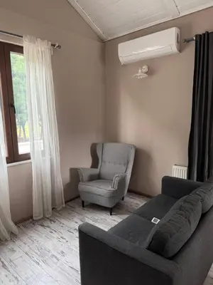 a living room with a couch and a chair and a window at Keyfe Kadir Garden Butik Otel in Orhangazi