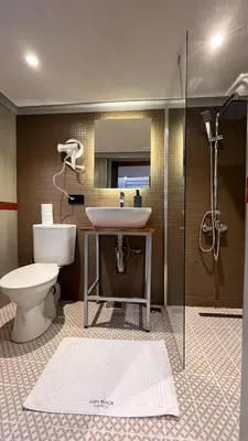 a bathroom with a toilet and a sink and a shower at Loft Black Sapanca in Sapanca