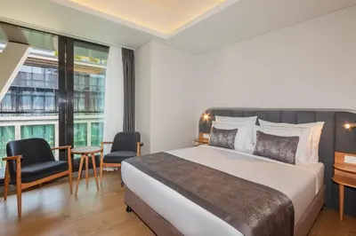 a hotel room with a bed and a large window at Meroddi Beyoğlu Residence in Istanbul