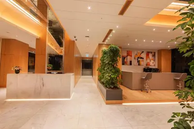 an office lobby with a large plant in the middle at Meroddi Beyoğlu Residence in Istanbul