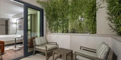 a hotel room with a balcony with chairs and a bed at The Ritus Hotel Istanbul Sultanahmet, Tapestry Collection by Hilton in Istanbul