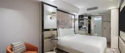 a bedroom with a white bed and a chair at The Ritus Hotel Istanbul Sultanahmet, Tapestry Collection by Hilton in Istanbul
