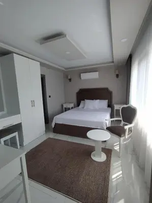 a bedroom with a bed and a table and a chair at Daly Resort 1 in Sapanca