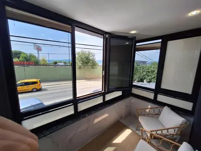 a room with windows with a chair and a yellow taxi at Daly Resort 1 in Sapanca