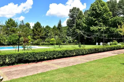 a park with a swimming pool and trees at Villa Riva Garden in Polonezkoy