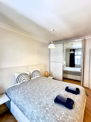 a bedroom with a large bed and a mirror at Deluxe Duplex in city center with 210 degrees Bosphorus viewed in Istanbul