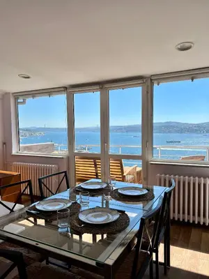 a dining room with a table and views of the ocean at Deluxe Duplex in city center with 210 degrees Bosphorus viewed in Istanbul