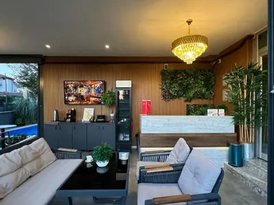 a living room with a couch and chairs and a chandelier at One Suit in Kartepe