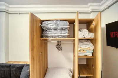 a small closet with wooden shelves and towels at SULTANAHMET oldcity nice suite in Istanbul