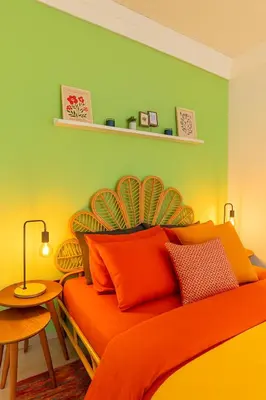a bedroom with an orange bed with a green wall at Maison Istanbulite in Istanbul