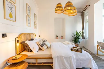 a bedroom with a bed with white sheets and pillows at Maison Istanbulite in Istanbul