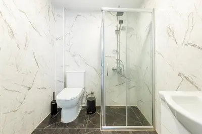 a bathroom with a toilet and a glass shower at Maison Istanbulite in Istanbul