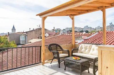 a patio with a couch and chairs on a balcony at Maison Istanbulite in Istanbul