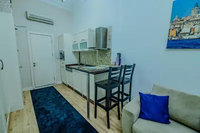 a living room with a couch and a kitchen at Istiklal Nil Suites in Istanbul